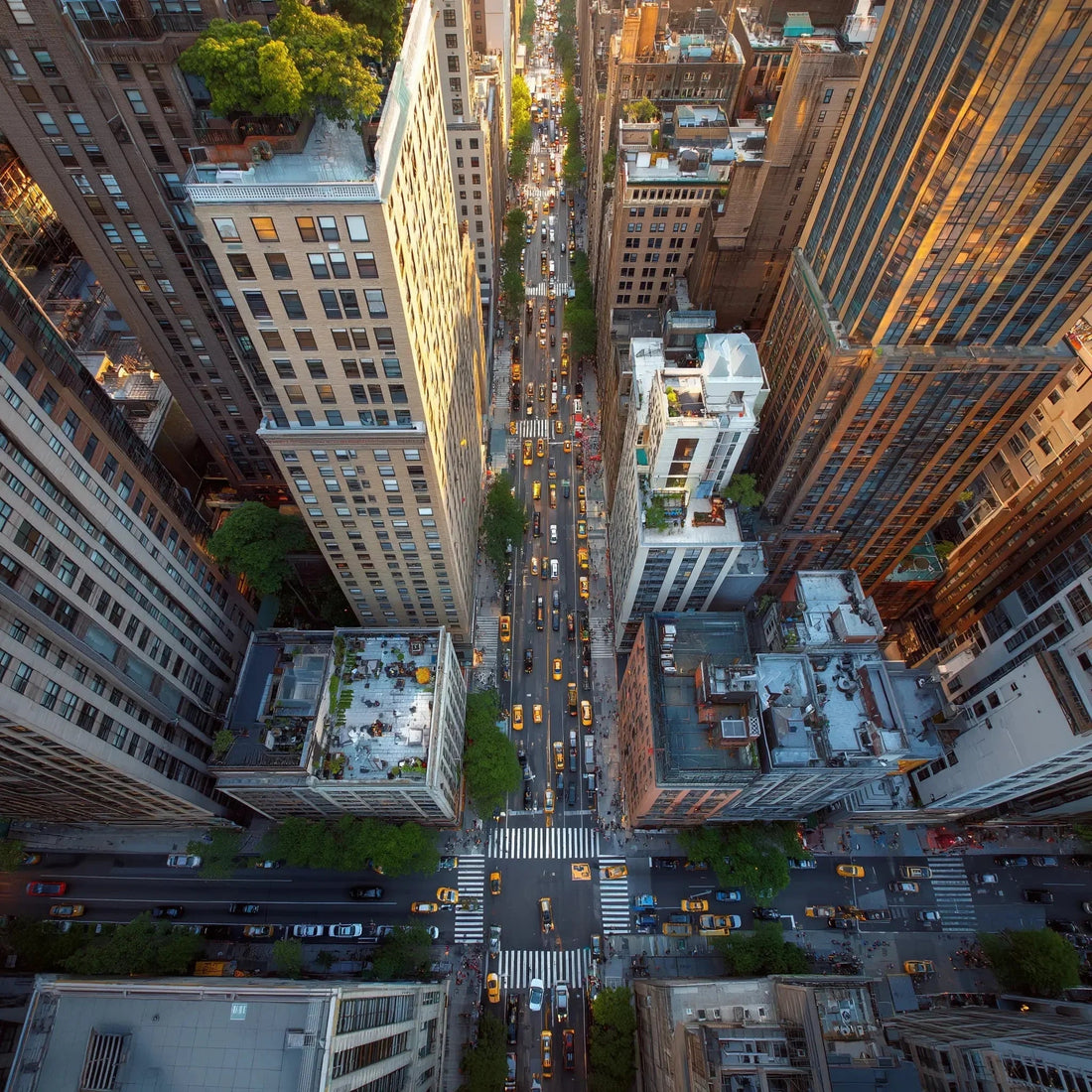 Aerial view of busy New York City streets with yellow taxis and tall skyscrapers.