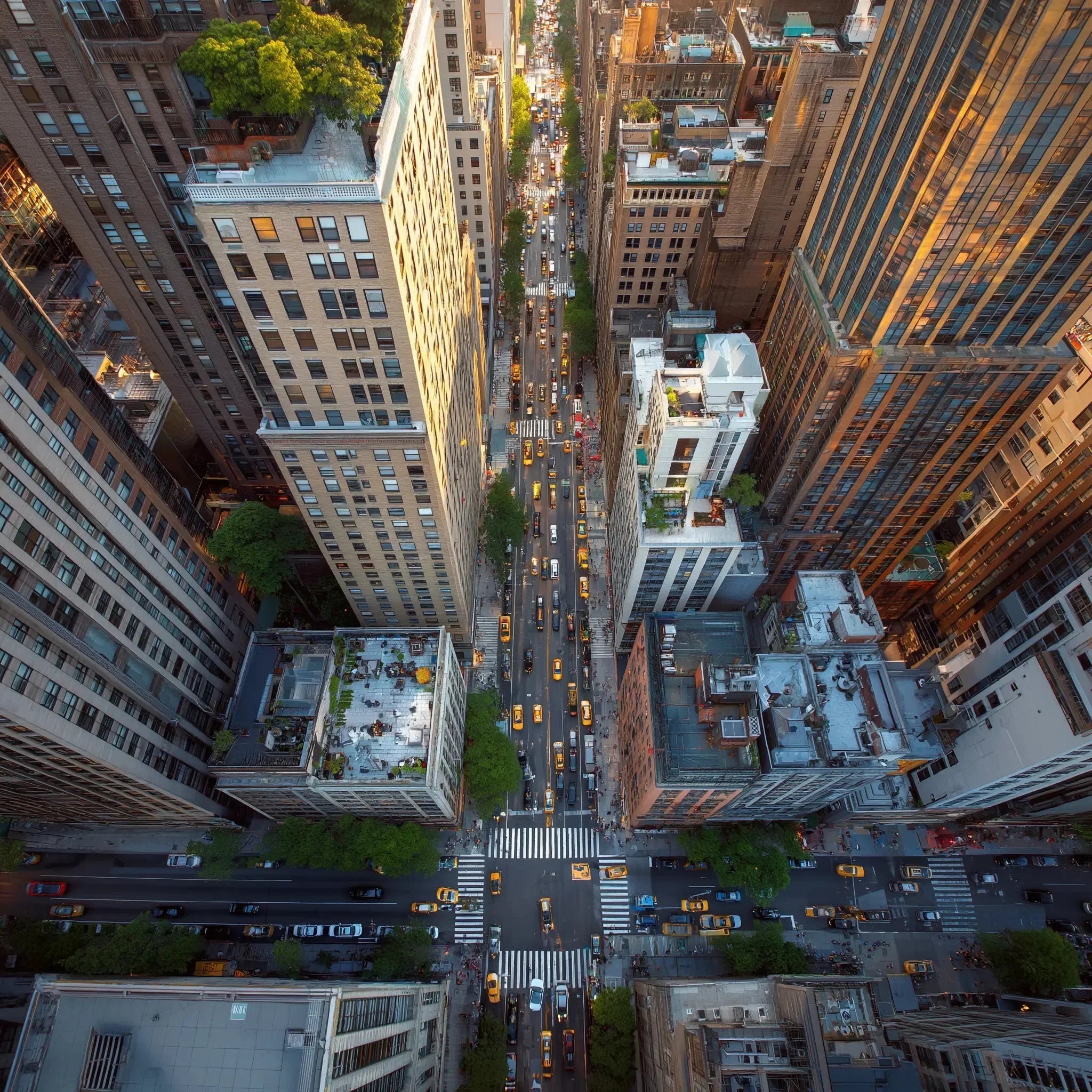 Aerial view of busy New York City streets with yellow taxis and tall skyscrapers.