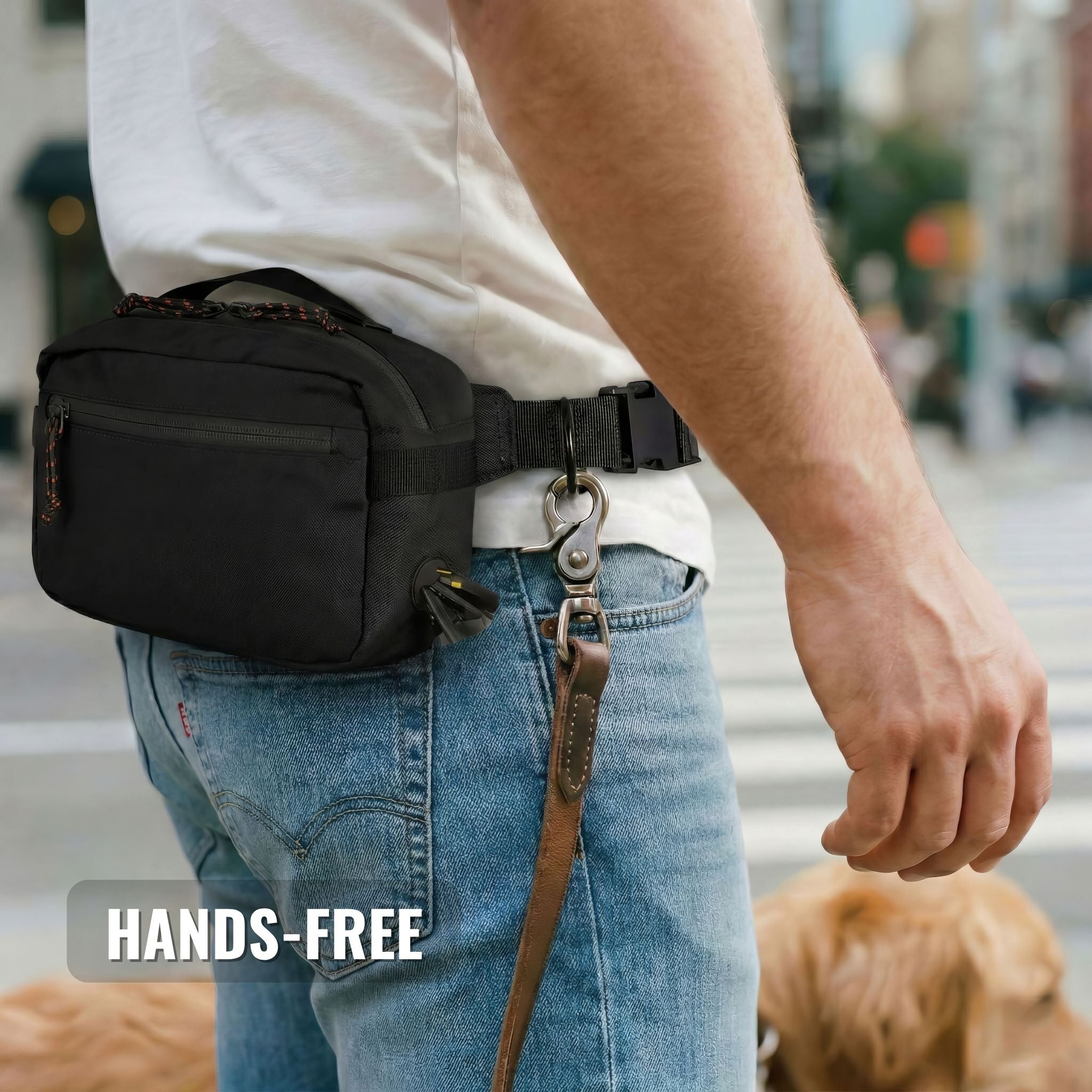 Woman wearing SUSU dog walking bag crossbody on cobblestone street, hands free with dog on leash