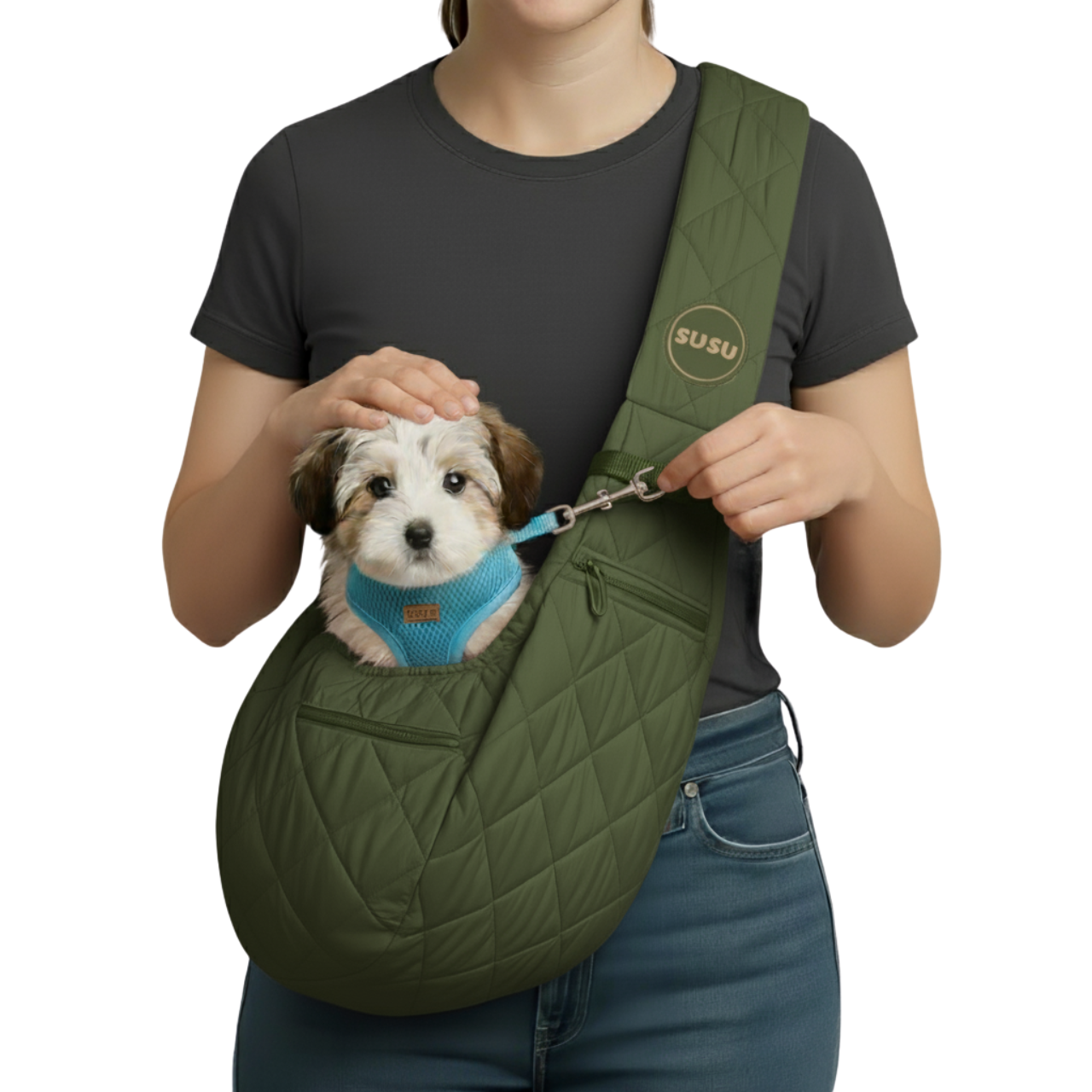 Woman wearing the SUSU Sling with a small dog inside, clipped to the built-in safety tether