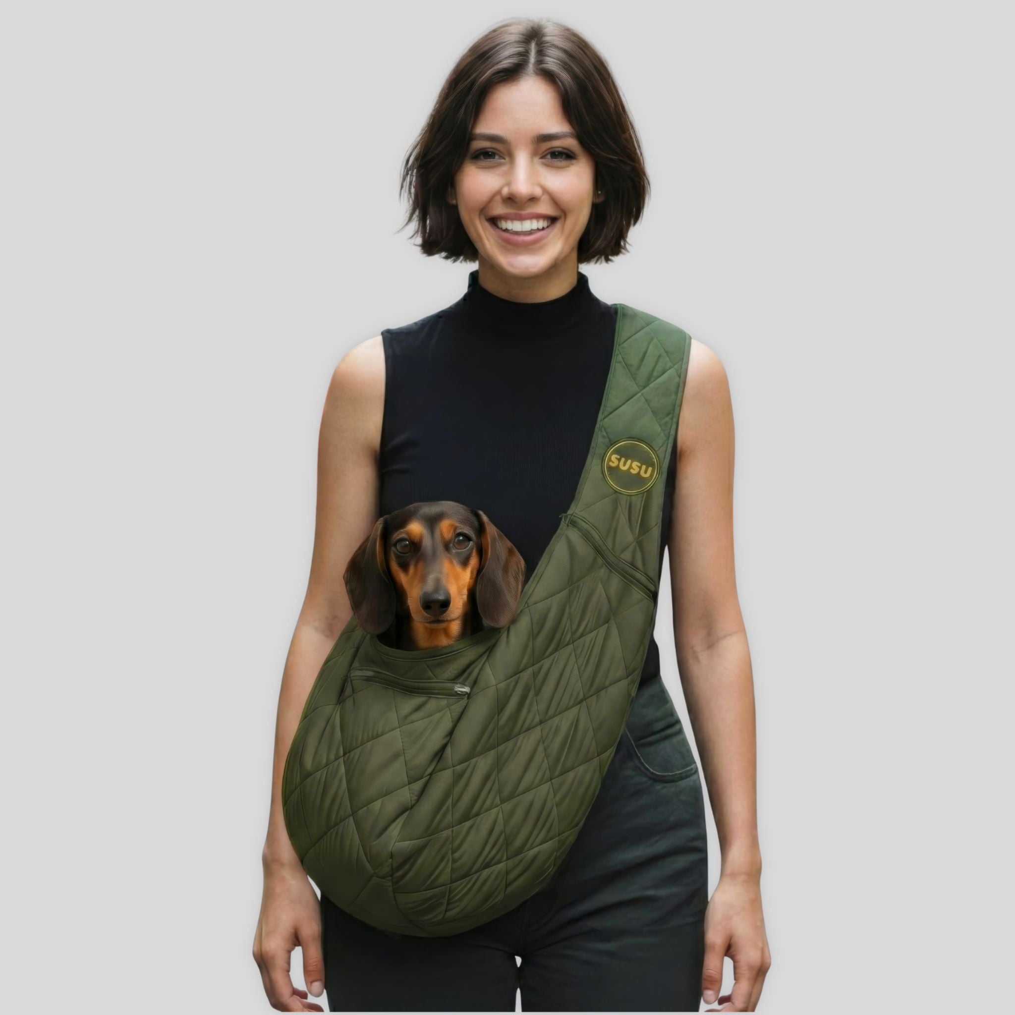 SUSU olive green dog sling carrier worn crossbody with a dachshund